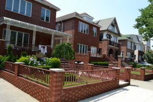 Buildings with same front yards.