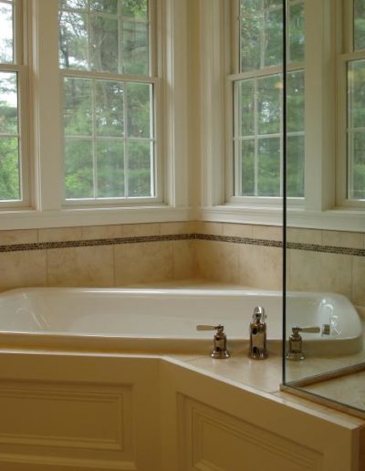 soaker tub with four windows above it