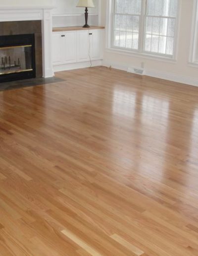 hardwood floors in a living room with a fireplace