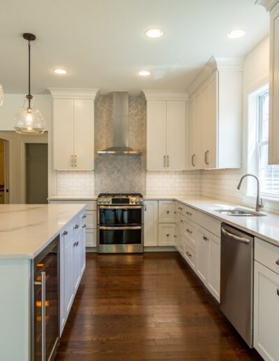 White kitchen with granite and stainless steel appliances