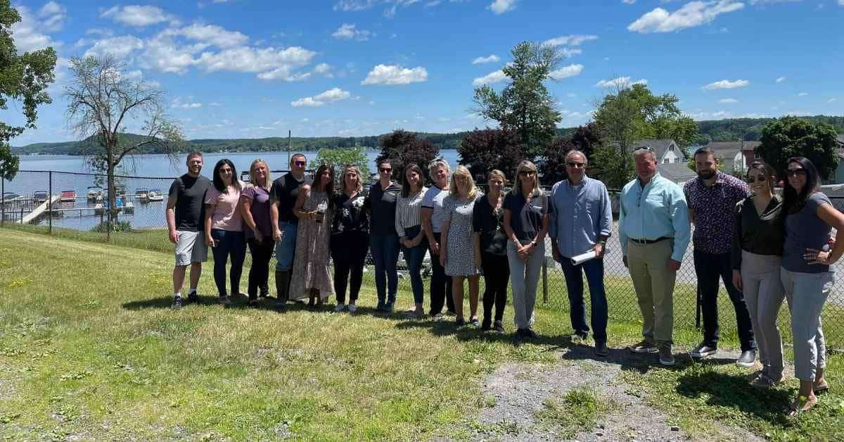 group of real estate workers standing outside on lawn