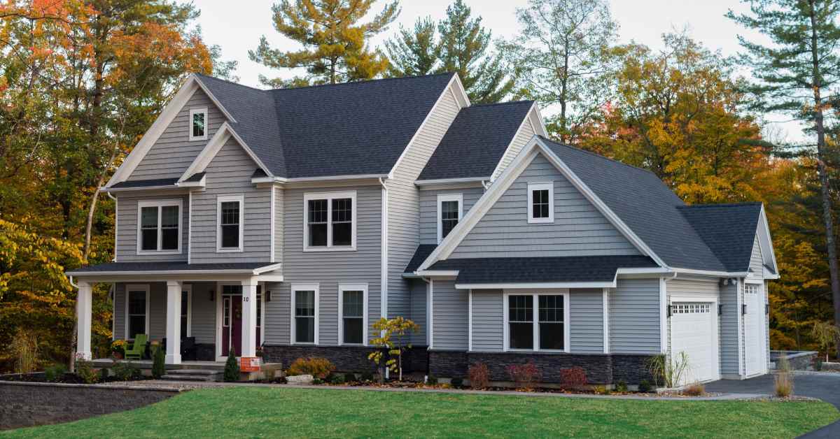 the exterior of a large home with fall colors on the trees