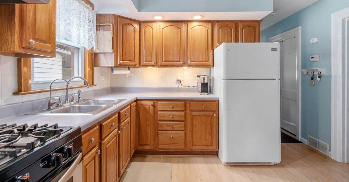 a large home kitchen with wooden cabinets