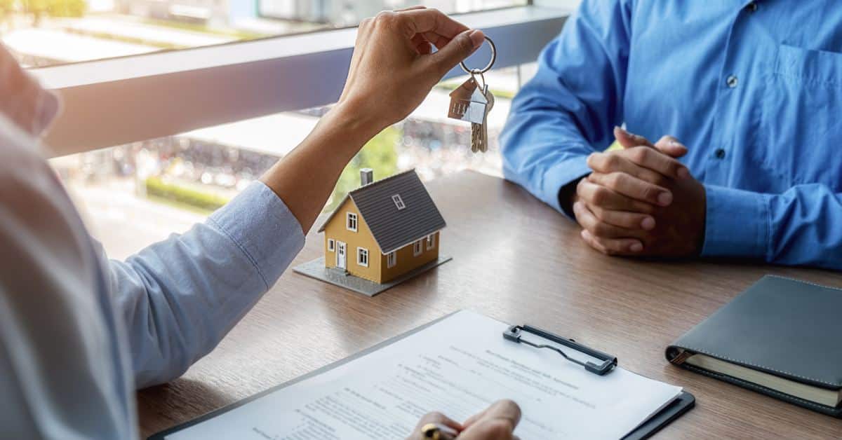 a person handing keys to another person