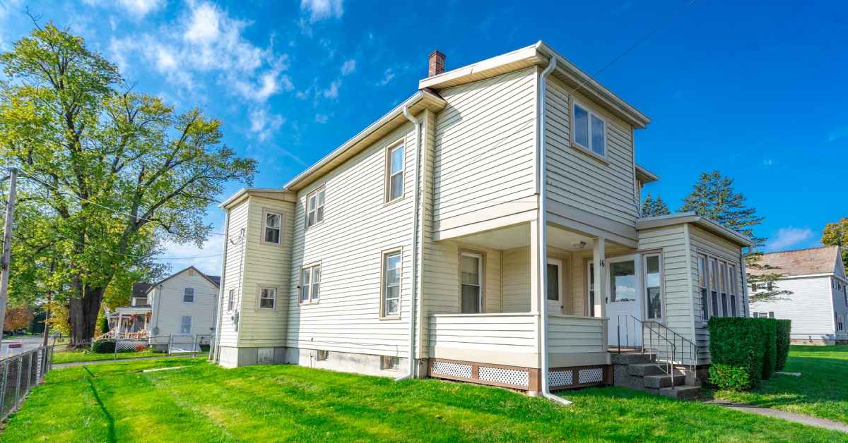 front view of a two story home and a grassy lawn