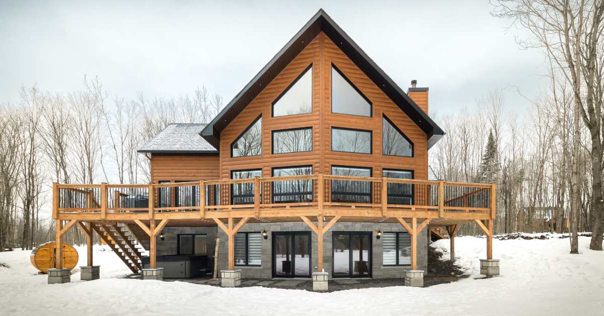 exterior of a large wooden home with many windows during winter