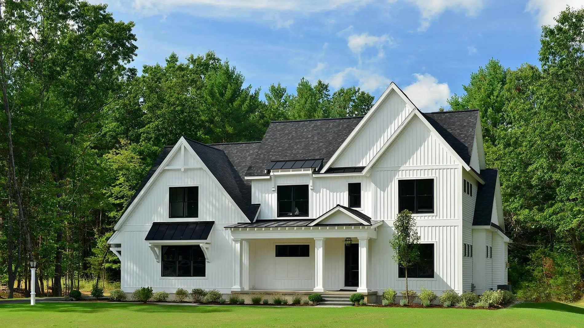 white colonial house with black trim and windows